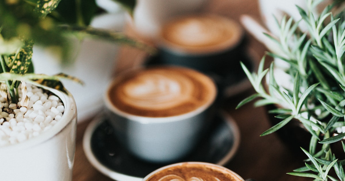 A single cup of black coffee brewed for one person on a wooden kitchen table
