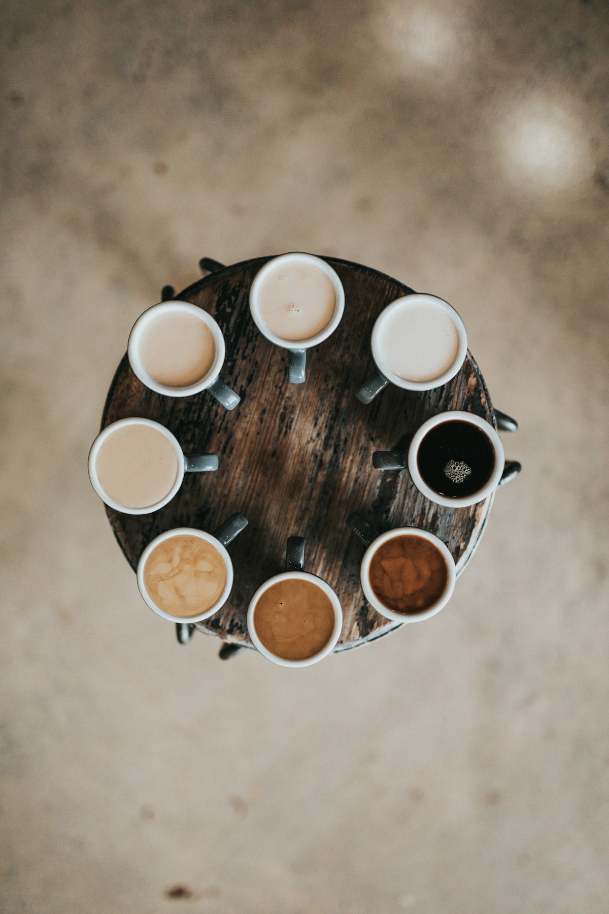 Coffee cupping setup with fresh beans, spoons, and tasting cups on a wooden table
